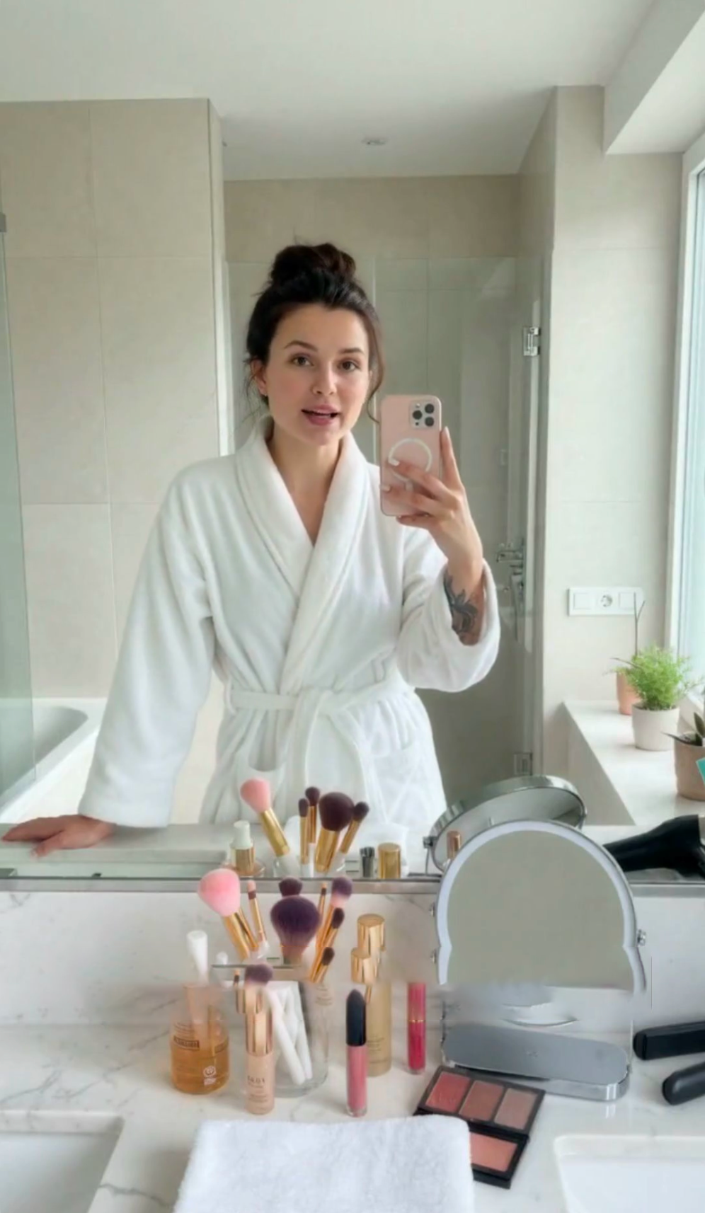 Beauty presenter filming beside hair and makeup tools